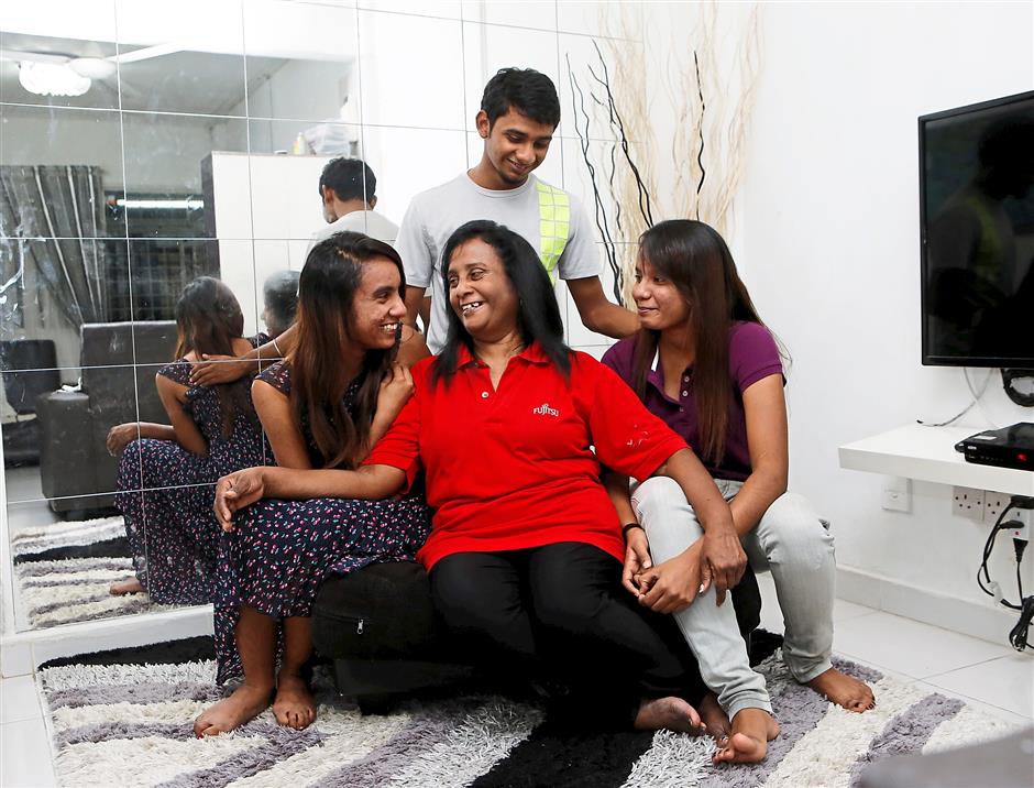 Life goes on:Jothy and her children have built a happy life for themselves. Photo: The Star/Azhar Mahfof